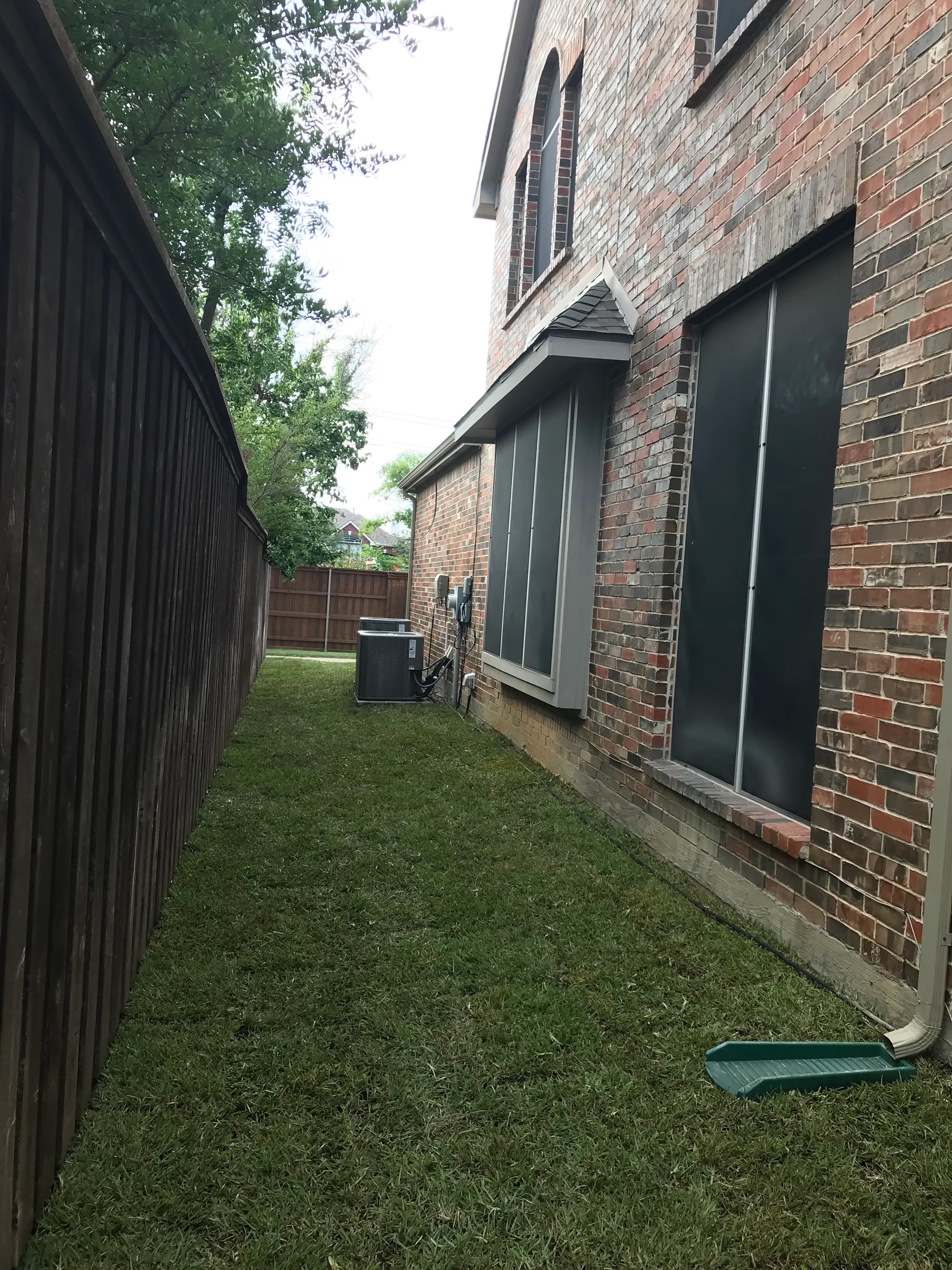 The same front yard after renovation with fresh sod and defined beds
